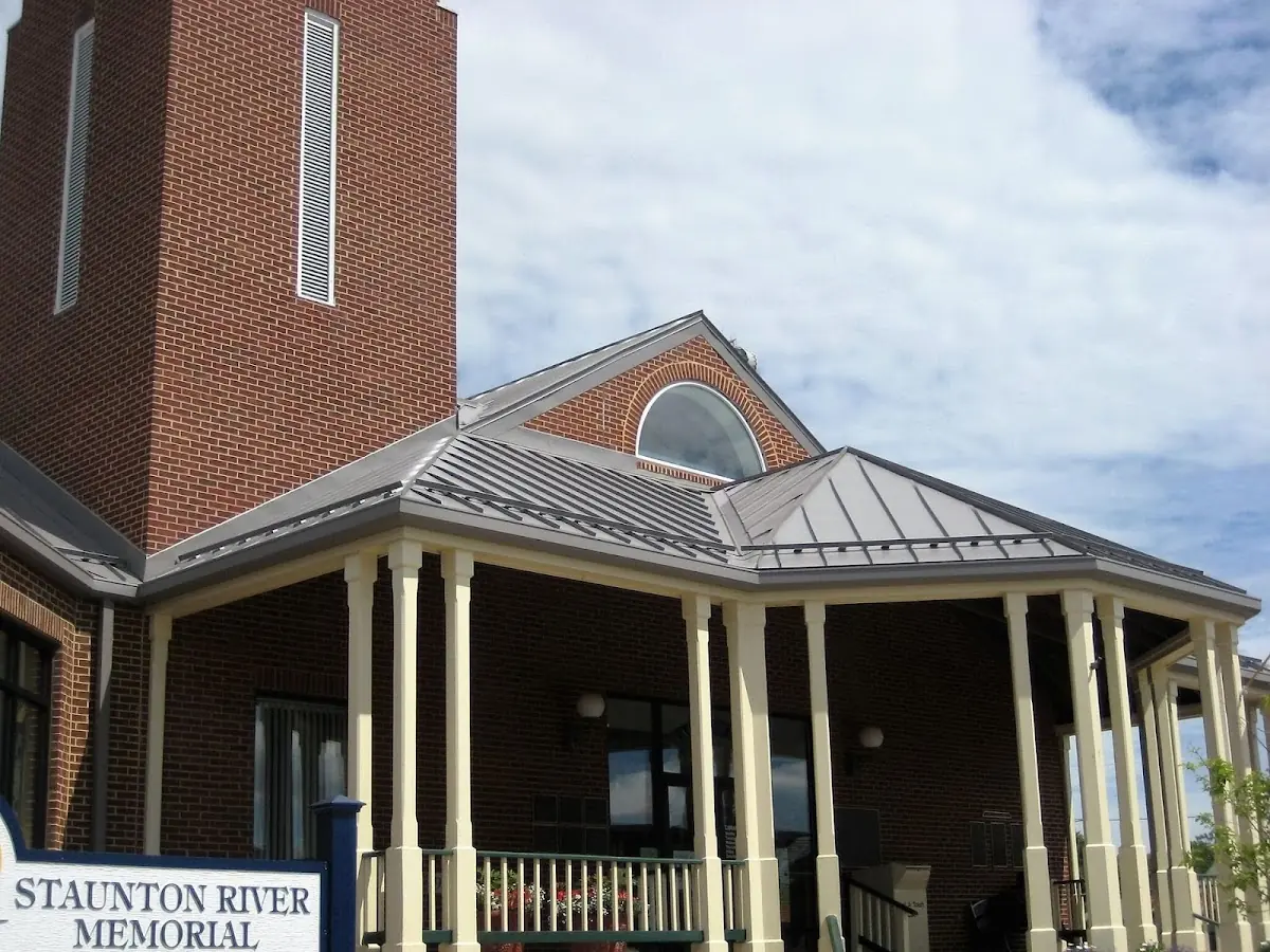 Skilled roofing craftsmen working on a residential roof in Amboy